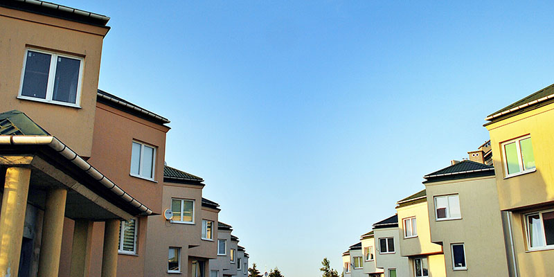 Row of New Apartment Buildings With Blue Sky in Background